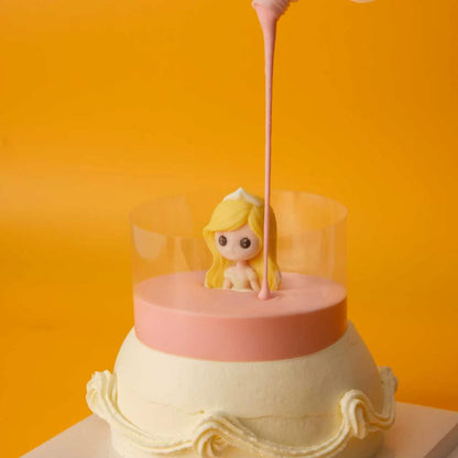 Pink glaze filling the clear collar around the Princess Cake