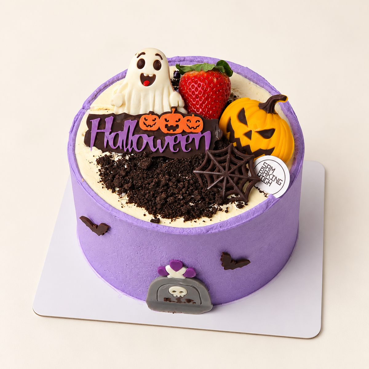Purple Halloween cake with ghost and pumpkin decorations